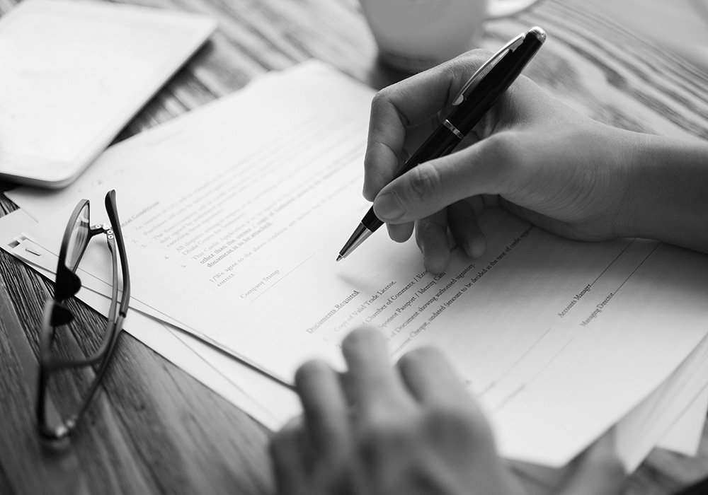 Businessman examining papers at table